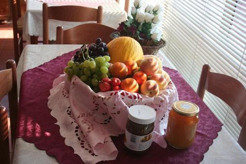 a table with a bowl of fruit on a table at Parco Delle Tre Fontane in Nicolosi