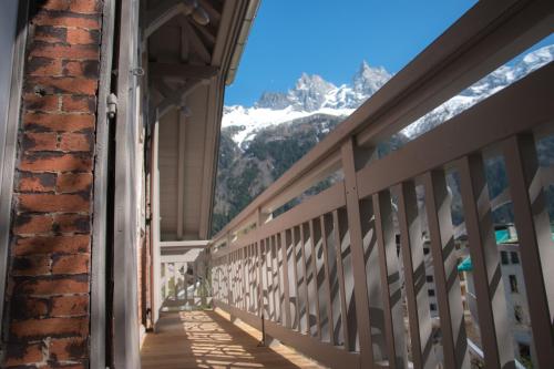 a balcony with a view of a snow covered mountain at Appart'Hotel Aiguille Verte & Spa in Chamonix-Mont-Blanc