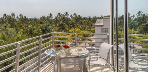 a balcony with a table with flowers on it at SBV Luxury Ocean Hotel Suites in Miami Beach