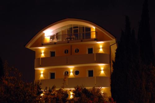 a large building with a clock on the front of it at Hotel Alverì in Mestre