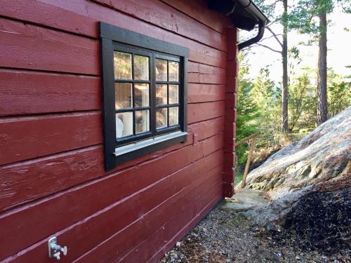 a window on the side of a red house at Näkna Hill in Åby