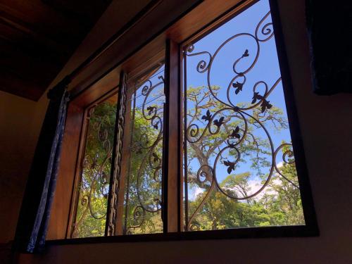 a window with a view of a tree at Arco Iris Lodge in Monteverde Costa Rica