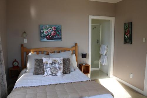 a bedroom with a bed with pillows on it at The Point B&B in Kaikoura