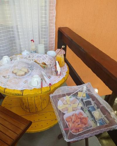 ein gelber Tisch mit Essen darüber in der Unterkunft Pousada Casa Di Gaya Guesthouse in Cabo Frio