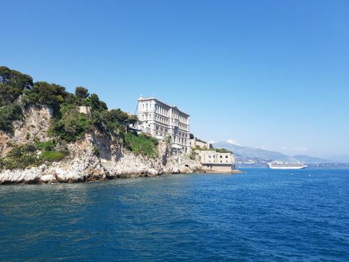 an island in the water with buildings on it at Plein coeur de Monaco, à 300 mètres à pied du port de Monaco, 4 pièces dans des escaliers vue mer exceptionnelle in Monte Carlo