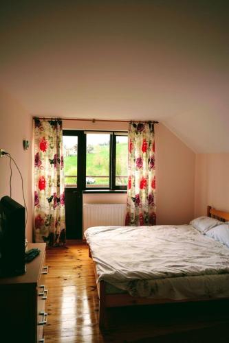 a bedroom with a bed and two windows at MonteCrai in Şirnea