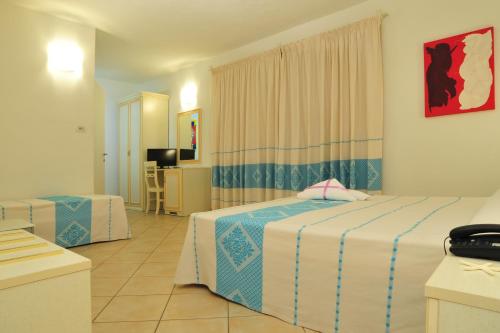 Un pat sau paturi într-o cameră la Hotel Stella Marina