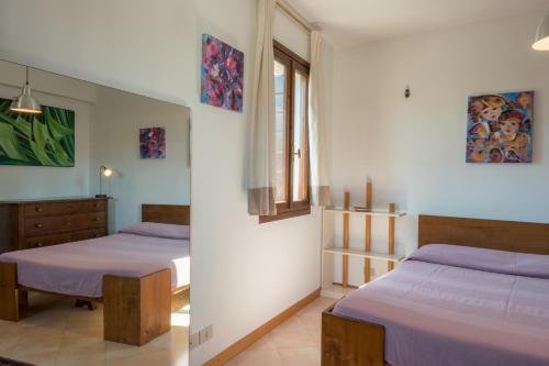 Säng eller sängar i ett rum på Armonie di Casa, vicino a San Marco