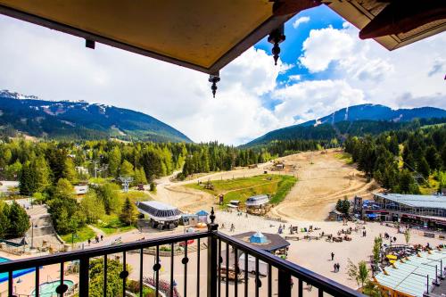 a view from a balcony of a ski resort with mountains at Sundial Hotel in Whistler