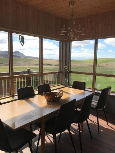 ein Esszimmer mit einem großen Tisch und Stühlen in der Unterkunft Stóra-Mörk III Guesthouse in Stora Mork