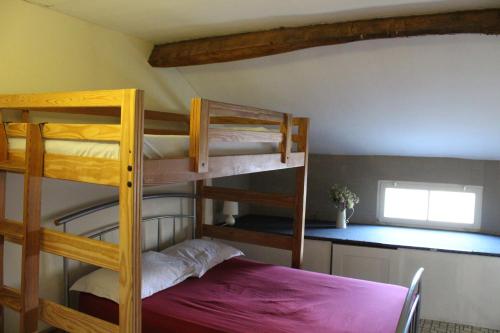 two bunk beds in a room with a purple bed at Moulin2Roues in Artannes-sur-Thouet