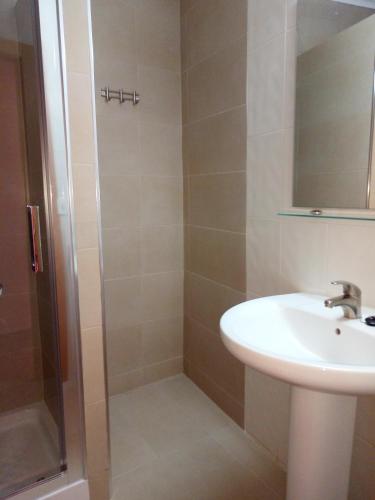 a bathroom with a sink and a shower at Hotel Iris in Benidorm