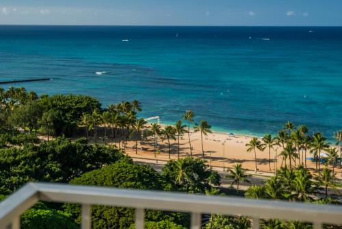 a view of the beach from the balcony of a resort at Queen Kapiolani Hotel in Honolulu
