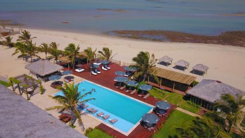 an aerial view of a resort with a pool and a beach at Manati in Barra Grande