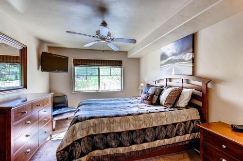 a bedroom with a bed and a ceiling fan at First Tracks in Steamboat Springs