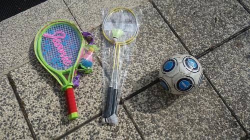 two tennis rackets and a ball on the ground at Apartment Mia in Donja Pačetina