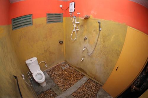 a bathroom with a shower and a toilet at Airport Tourist Hostel in Katunayake