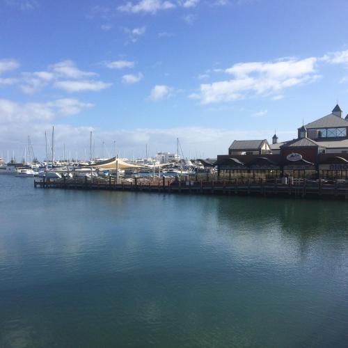 a dock with a marina with boats in the water at Breakwater Short Stay in Mandurah