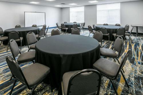 a conference room with a round table and chairs at Wingate by Wyndham Dallas Love Field in Dallas