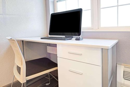 a desk with a computer on top of it at Microtel Inn & Suites Urbandale in Urbandale
