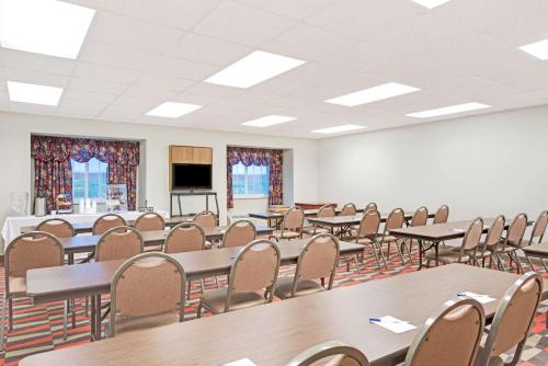 a large room with tables and chairs and a podium at Microtel Inn & Suites Urbandale in Urbandale