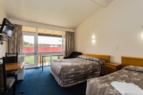 a hotel room with two beds and a window at Blenheim Road Motor Lodge in Christchurch