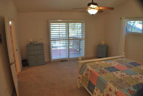 a bedroom with a bed and a dresser and a window at Big Tom's Cabin by Yosemite, lake and trails in Groveland