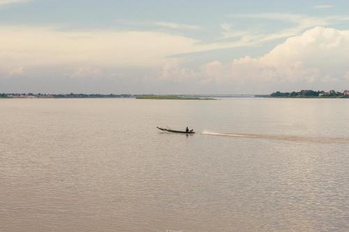 a person in a boat on the water at Vieng Khong Hotel in Mukdahan
