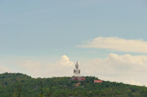 a building on top of a hill with a tower at Vieng Khong Hotel in Mukdahan