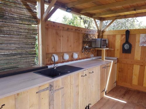 a kitchen with a sink in a wooden cabin at Analaya in Vias