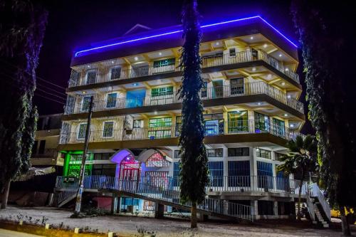 a building with blue lights on it at night at The Joy Hotel in Voi