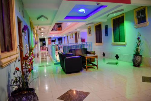 a lobby with a couch and a table in a room at The Joy Hotel in Voi