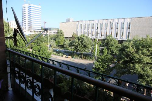 a balcony with a view of a street and buildings at A Flower in Tirana in Tirana