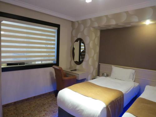 Кровать или кровати в номере Tempo Residence Comfort Izmir