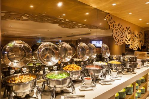 a buffet line with many pots and pans of food at Green World Taipei Station in Taipei