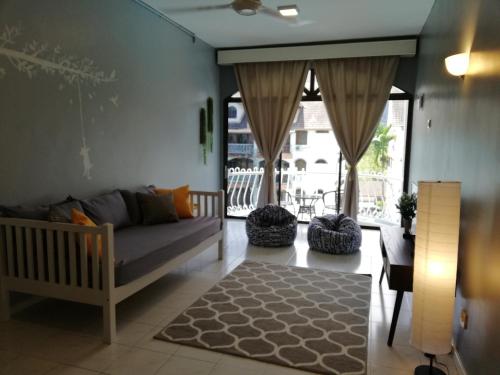 a living room with a couch and a table at Pino's Place in Kuah