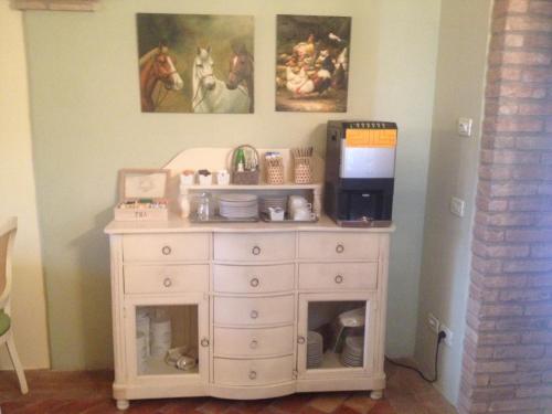 a white dresser in the corner of a room at Hospitale I Mori in Asola