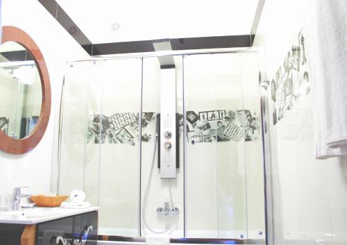 a shower with a glass door in a bathroom at Hotel Dom Aktera in Odesa