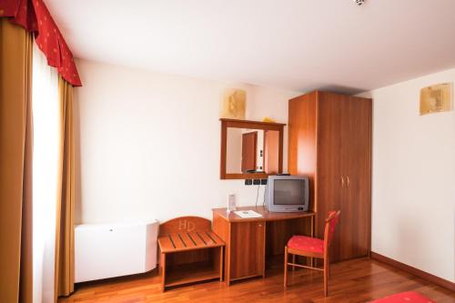 a small room with a desk and a tv at Hotel Dall'Ongaro in Ghirano