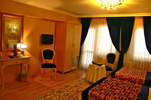 a room with a bed, a chair, and a lamp at Divas Hotel in Istanbul