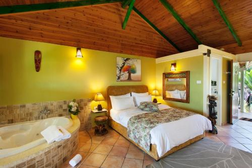 a bedroom with a bed and a bath tub at Out of Africa Resort in Had Nes