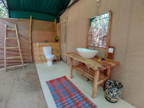 a bathroom with a sink and a toilet at Back of Beyond Dune Camp Yala in Yala
