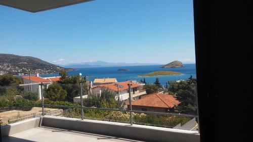 a view of the ocean from a balcony at Seaview Pool Villa near Beach and Athens Airport in Porto Rafti