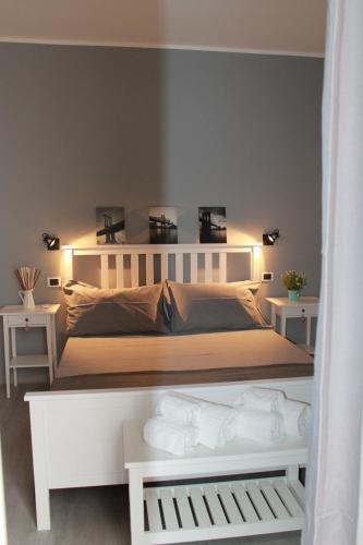 a bedroom with a white bed with lights on it at Casa Mirò in Polignano a Mare
