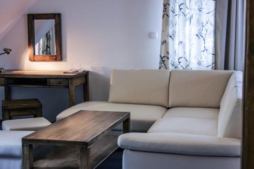 a living room with a couch and a table at Penzión Teniscentrum in Tatranská Lomnica