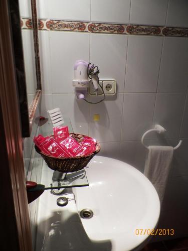 a bathroom sink with a basket on top of it at Casa Francisco el de Siempre in El Palmar