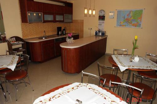 a kitchen and dining room with two tables and a counter at Pokoje Hotelowe Wiktoria in Goczałkowice Dolne