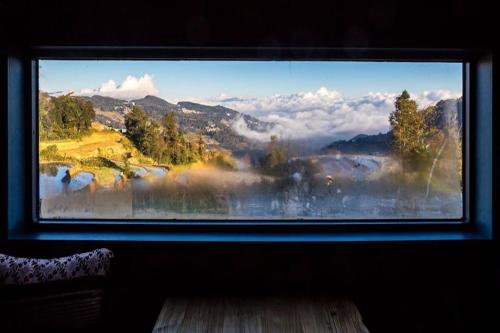 a window with a view of a mountain view at The Twelve Manor•Terraces Lodge in Yuanyang