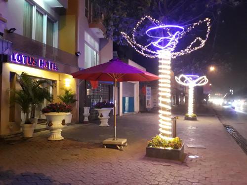 a city street with christmas lights and an umbrella at Lotus Hotel Hai Duong in Hải Dương