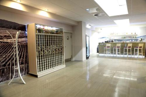 a room with bar stools and a display in a store at Chaty - Resort AQUA MARIA in Veľaty